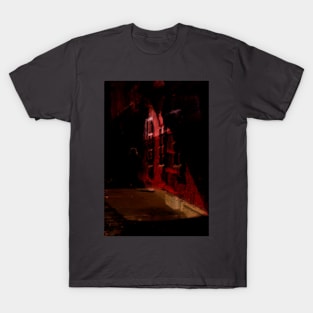 Special processing. Person walking at night, on dark street, with stone walls. Red. T-Shirt